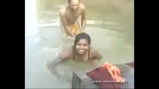 Young girl bathing in river with boob press